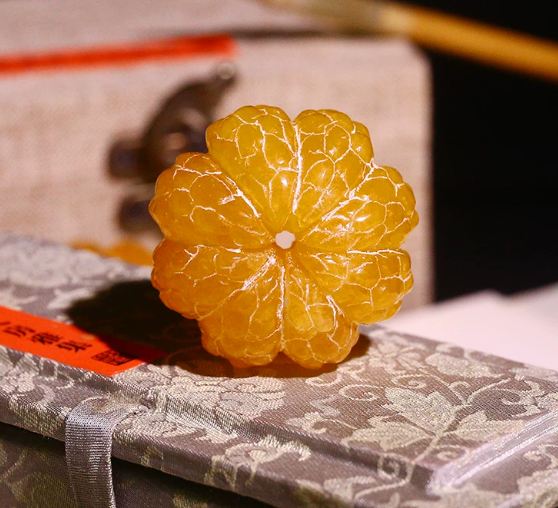 A carved yellowstone orange, symbolizing a tranquil mind, solidified learning, and the safeguarding of wisdom.